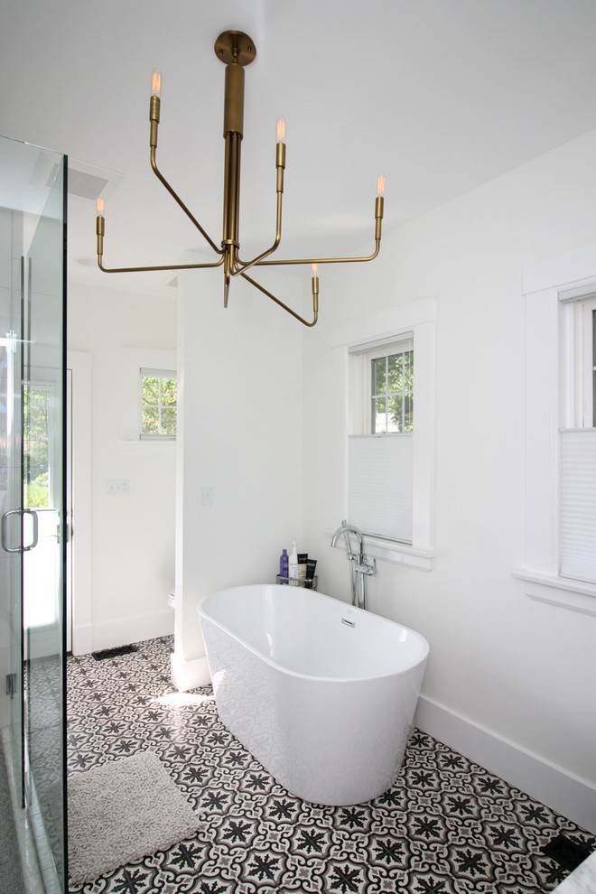 Freestanding bathtub - farmhouse master cement tile floor and black floor freestanding bathtub idea in St Louis with white walls and an undermount sink