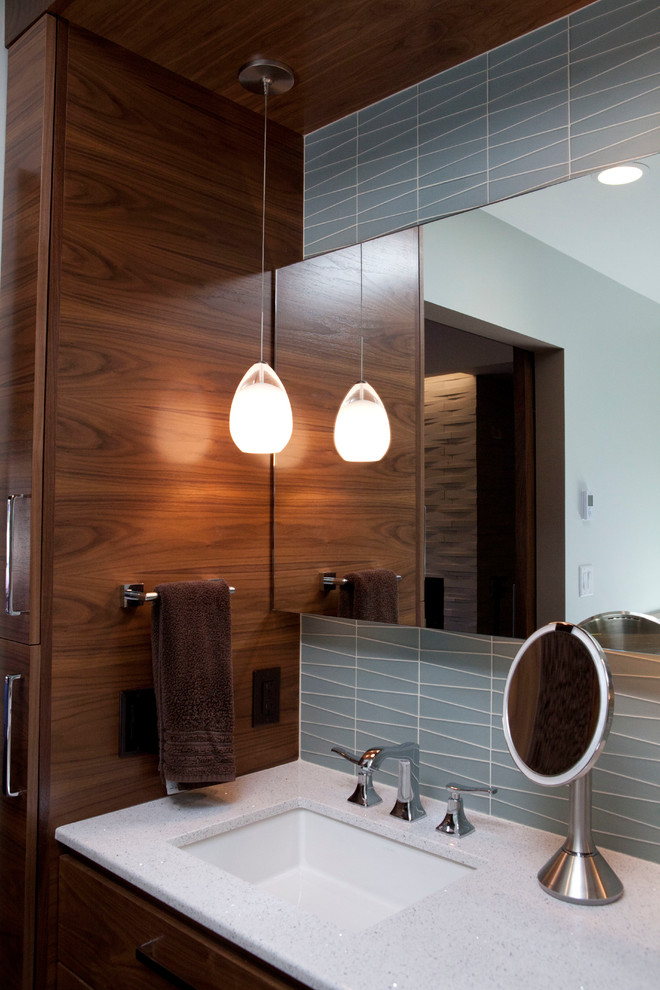 Photo of a large modern bathroom in San Francisco with a submerged sink, flat-panel cabinets, medium wood cabinets, engineered stone worktops, a submerged bath, a walk-in shower, a one-piece toilet, multi-coloured tiles, ceramic tiles, blue walls and ceramic flooring.
