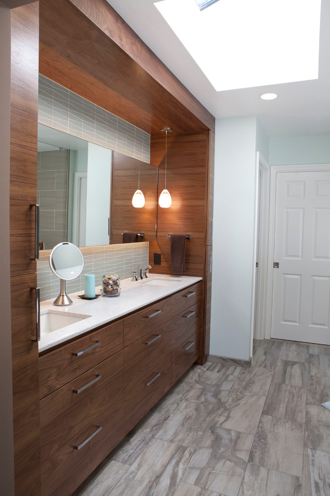 Inspiration for a large modern multicolored tile and ceramic tile ceramic tile doorless shower remodel in San Francisco with an undermount sink, flat-panel cabinets, medium tone wood cabinets, quartz countertops, an undermount tub, a one-piece toilet and blue walls