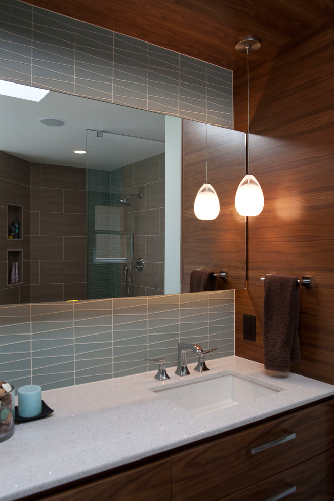 Example of a large minimalist multicolored tile and ceramic tile ceramic tile doorless shower design in San Francisco with an undermount sink, flat-panel cabinets, medium tone wood cabinets, quartz countertops, a one-piece toilet and blue walls