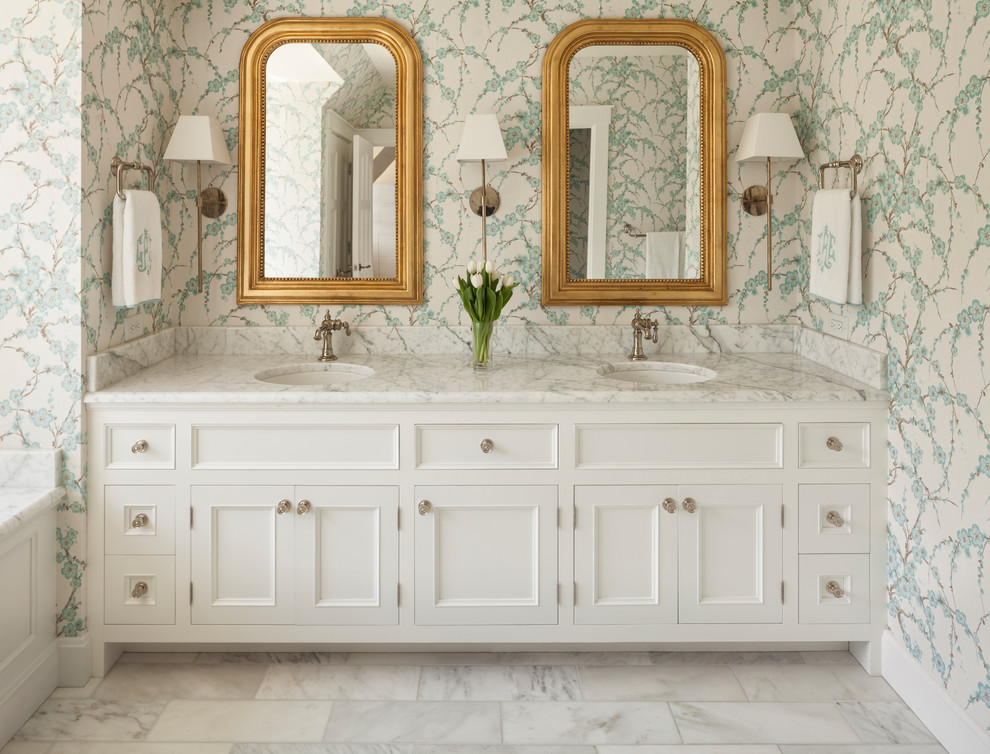 Photo of a classic ensuite bathroom in Cincinnati with recessed-panel cabinets, white cabinets, multi-coloured walls, marble flooring, a submerged sink and white floors.