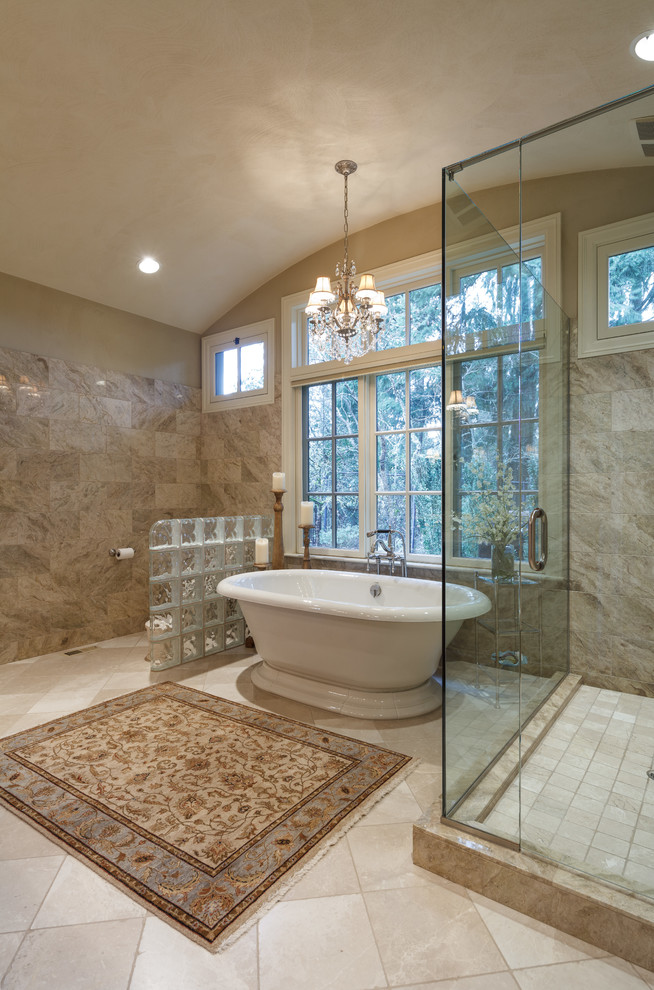 Inspiration for a large traditional ensuite bathroom in Other with raised-panel cabinets, medium wood cabinets, a freestanding bath, a corner shower, a two-piece toilet, beige tiles, marble tiles, beige walls, marble flooring, marble worktops and a built-in sink.