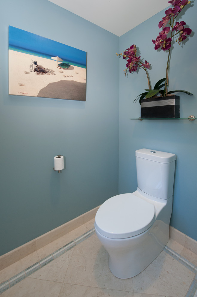 World-inspired cloakroom in Hawaii with flat-panel cabinets, medium wood cabinets, a two-piece toilet, white tiles, stone tiles, beige walls, limestone flooring, a submerged sink and quartz worktops.