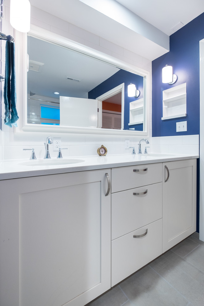 Bathroom - mid-sized traditional master white tile and ceramic tile porcelain tile bathroom idea in Portland with recessed-panel cabinets, white cabinets, a two-piece toilet, blue walls, an undermount sink and quartz countertops
