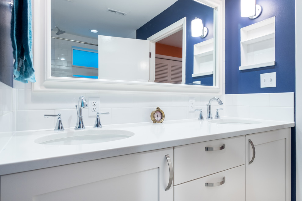 Example of a mid-sized classic master white tile and ceramic tile porcelain tile bathroom design in Portland with recessed-panel cabinets, white cabinets, a two-piece toilet, blue walls, an undermount sink and quartz countertops