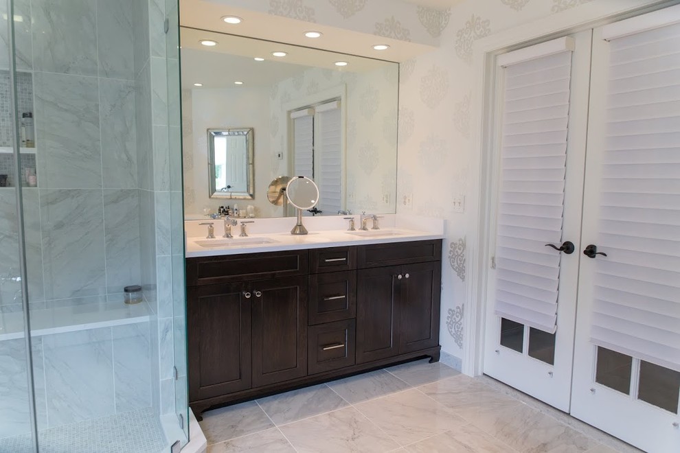 Large traditional ensuite bathroom in New York with a submerged sink, recessed-panel cabinets, dark wood cabinets, quartz worktops, a freestanding bath, a corner shower, a two-piece toilet, white tiles, stone tiles and marble flooring.