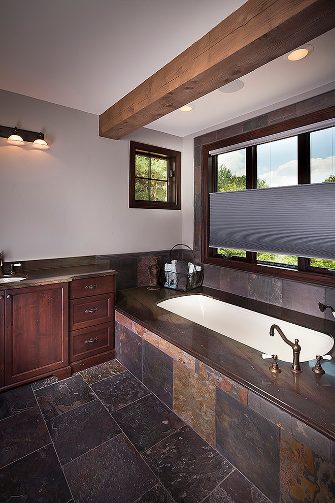 Medium sized traditional ensuite bathroom in Detroit with a built-in sink, shaker cabinets, medium wood cabinets, limestone worktops, a built-in bath, a corner shower, a two-piece toilet, brown tiles, mosaic tiles, white walls and terracotta flooring.