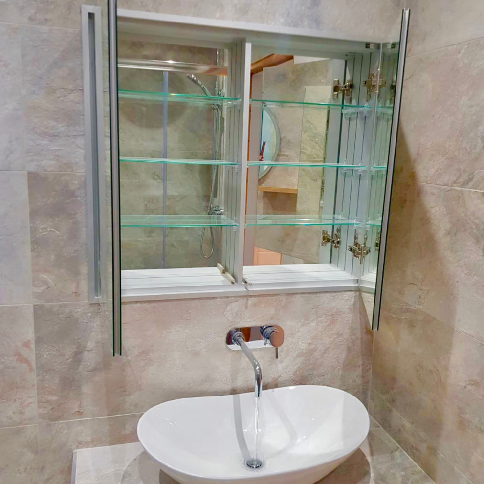 Design ideas for a medium sized contemporary family bathroom in Dublin with raised-panel cabinets, white cabinets, a corner shower, a one-piece toilet, beige tiles, mosaic tiles, beige walls, ceramic flooring, a vessel sink, concrete worktops, beige floors, a sliding door and beige worktops.