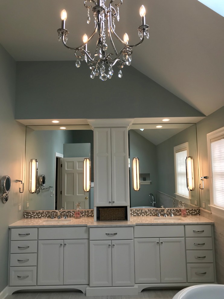 Design ideas for a large traditional ensuite bathroom in Chicago with flat-panel cabinets, white cabinets, a freestanding bath, a walk-in shower, a two-piece toilet, grey tiles, porcelain tiles, blue walls, porcelain flooring, a submerged sink, engineered stone worktops, grey floors, an open shower and white worktops.