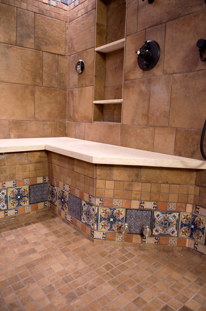 Design ideas for a large mediterranean ensuite bathroom in Phoenix with beaded cabinets, medium wood cabinets, a built-in bath, a walk-in shower, multi-coloured tiles, cement tiles, blue walls, terracotta flooring, a submerged sink and limestone worktops.