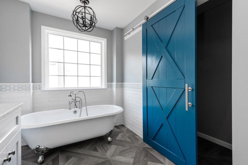 Example of a small classic master white tile and porcelain tile porcelain tile and gray floor claw-foot bathtub design in Charlotte with shaker cabinets, white cabinets, blue walls, an undermount sink, quartz countertops, a hinged shower door and white countertops