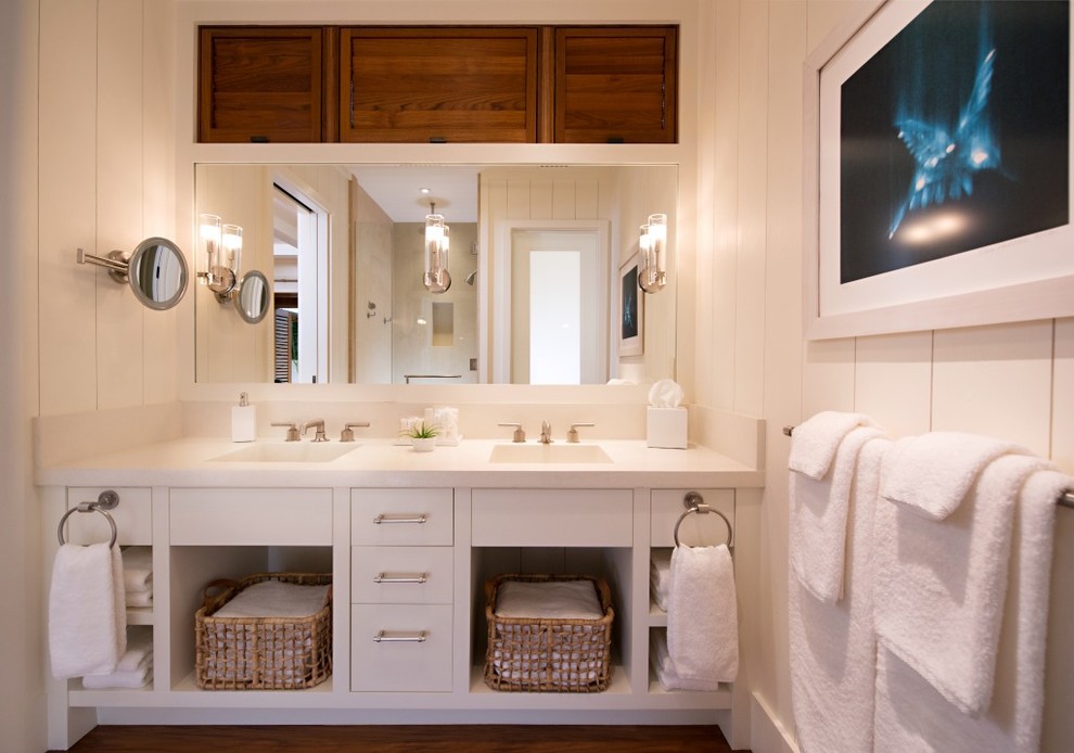 Large world-inspired ensuite bathroom in Hawaii with flat-panel cabinets, white cabinets, a submerged bath, white walls, medium hardwood flooring, engineered stone worktops, an alcove shower, a two-piece toilet, white tiles, stone slabs, an integrated sink, brown floors and a hinged door.