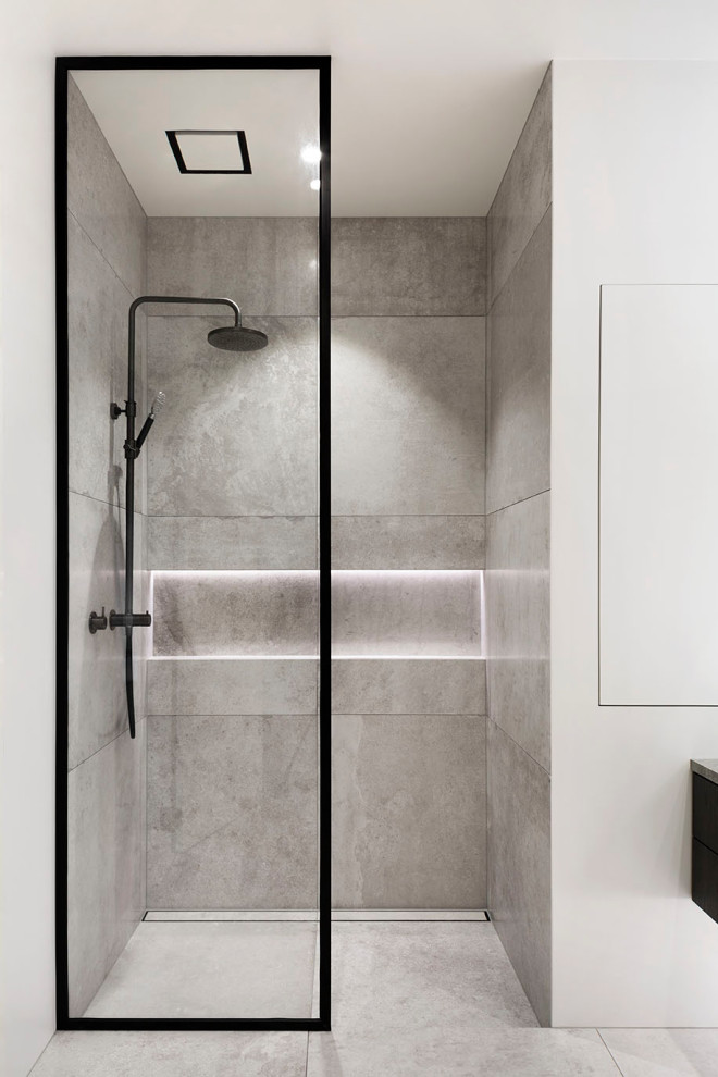 Contemporary ensuite bathroom in Auckland with brown cabinets, a freestanding bath, a walk-in shower, grey tiles, cement tiles, white walls, cement flooring, marble worktops, grey floors, an open shower, a single sink and a built in vanity unit.