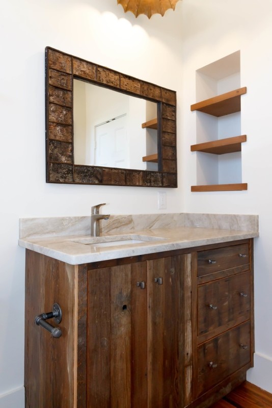 Rustik inredning av ett mellanstort badrum med dusch, med släta luckor, skåp i mörkt trä, vita väggar, mörkt trägolv, ett undermonterad handfat, marmorbänkskiva och brunt golv