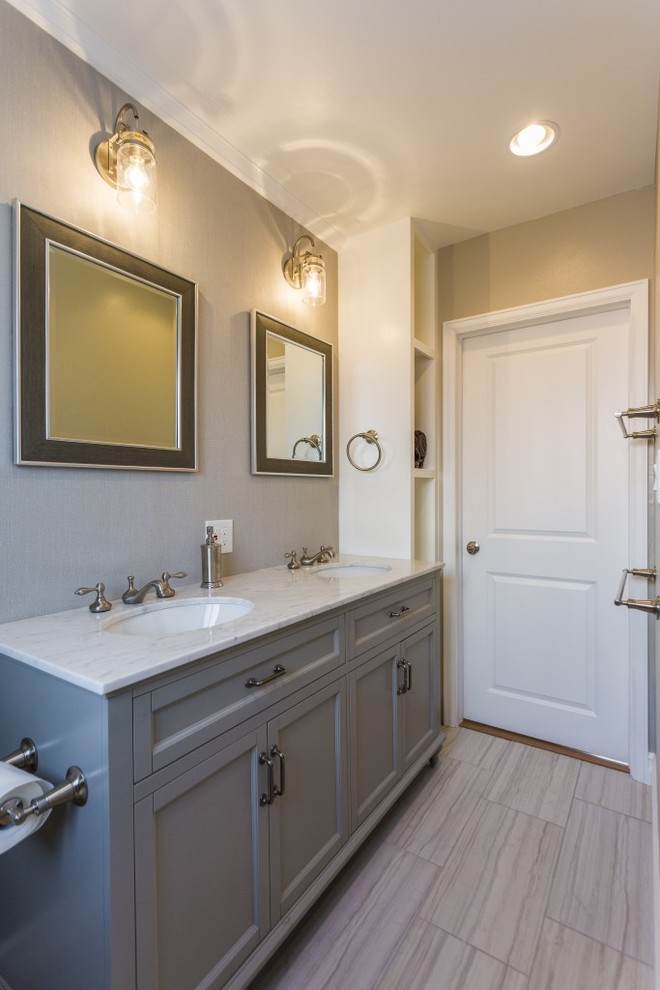 Photo of a medium sized contemporary ensuite bathroom in Denver with shaker cabinets, grey cabinets, a one-piece toilet, grey walls, porcelain flooring, a submerged sink and marble worktops.