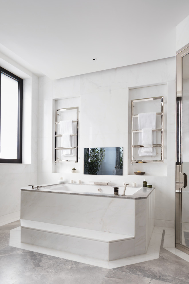 Inspiration for a contemporary bathroom in London with a submerged bath, white tiles and grey floors.