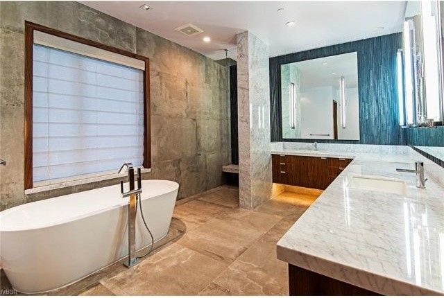Inredning av ett modernt stort en-suite badrum, med släta luckor, skåp i mörkt trä, ett fristående badkar, en hörndusch, grå kakel, ett undermonterad handfat, med dusch som är öppen, granitbänkskiva och beiget golv