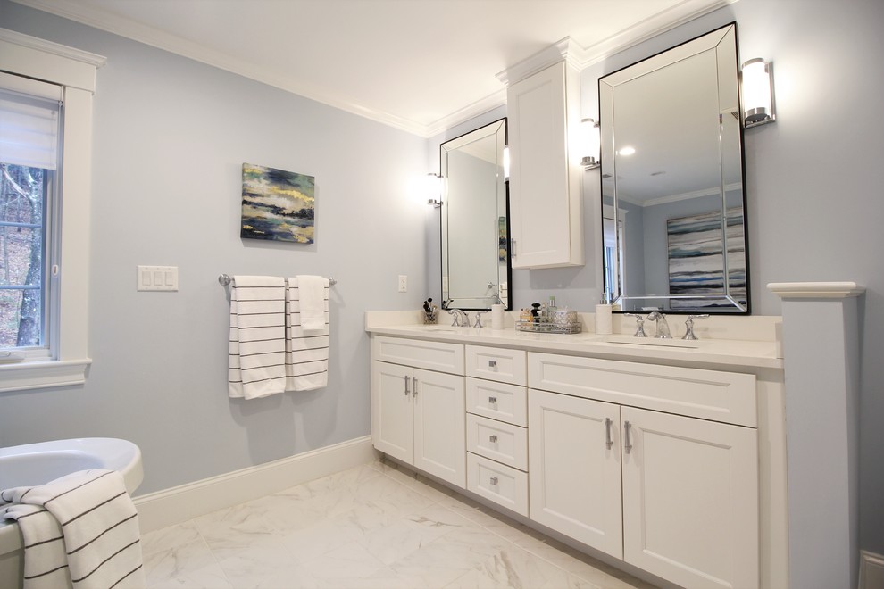 Example of a huge transitional master white tile and ceramic tile slate floor and white floor bathroom design in Boston with recessed-panel cabinets, white cabinets, a two-piece toilet, blue walls, an undermount sink, marble countertops, a hinged shower door and gray countertops