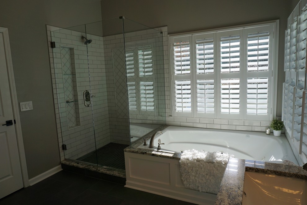 Inspiration for a medium sized traditional ensuite bathroom in Atlanta with raised-panel cabinets, white cabinets, a built-in bath, a corner shower, a two-piece toilet, white tiles, metro tiles, grey walls, porcelain flooring, a submerged sink, granite worktops, grey floors and a hinged door.