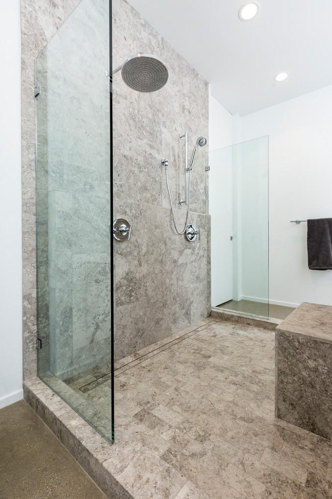 Photo of a large industrial ensuite bathroom in Cincinnati with a shower/bath combination, grey tiles, grey walls, porcelain flooring, grey floors, an open shower and stone tiles.