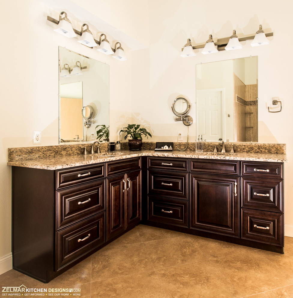 Inspiration for a large traditional ensuite bathroom in Orlando with a submerged sink, raised-panel cabinets, dark wood cabinets, granite worktops, a walk-in shower, beige tiles, porcelain tiles, beige walls and slate flooring.