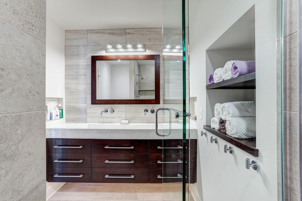 Photo of a medium sized contemporary shower room bathroom in Minneapolis with a trough sink, flat-panel cabinets, dark wood cabinets, concrete worktops, an alcove shower and grey tiles.
