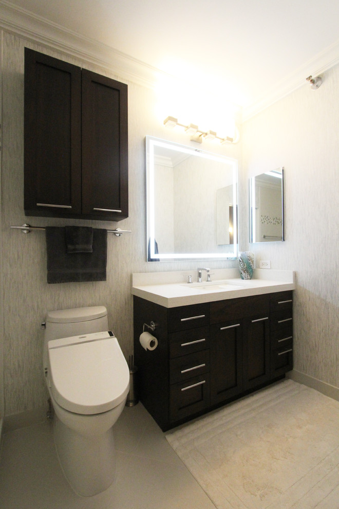 Inspiration for a small contemporary white tile and porcelain tile ceramic tile doorless shower remodel in Chicago with shaker cabinets, dark wood cabinets, a one-piece toilet, multicolored walls, an undermount sink and quartz countertops