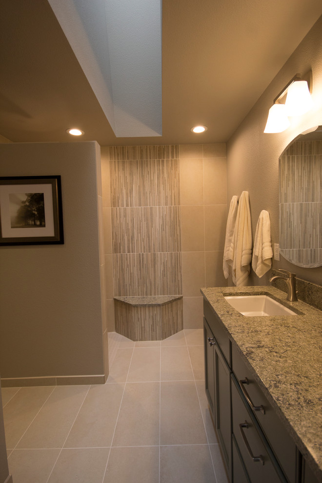 Example of a mid-sized transitional master beige tile and ceramic tile ceramic tile doorless shower design in Seattle with recessed-panel cabinets, green cabinets, a two-piece toilet, gray walls, an undermount sink and quartz countertops