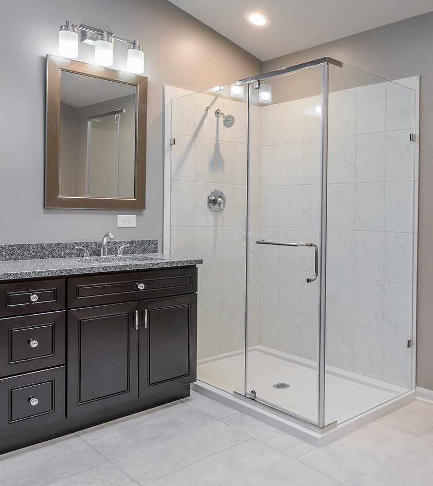 Inspiration for a medium sized classic ensuite bathroom in Chicago with shaker cabinets, black cabinets, a freestanding bath, a corner shower, white tiles, porcelain tiles, porcelain flooring, a submerged sink, granite worktops, multi-coloured floors, a hinged door, multi-coloured worktops and grey walls.