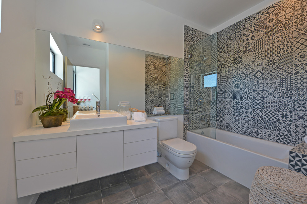 This is an example of a large contemporary shower room bathroom in Los Angeles with flat-panel cabinets, white cabinets, an alcove bath, a walk-in shower, a two-piece toilet, black and white tiles, cement tiles, white walls, cement flooring, a vessel sink, engineered stone worktops, grey floors and an open shower.