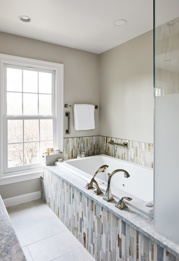 Medium sized traditional ensuite bathroom in DC Metro with blue cabinets, a built-in bath, a corner shower, beige tiles, beige walls, white floors and a sliding door.