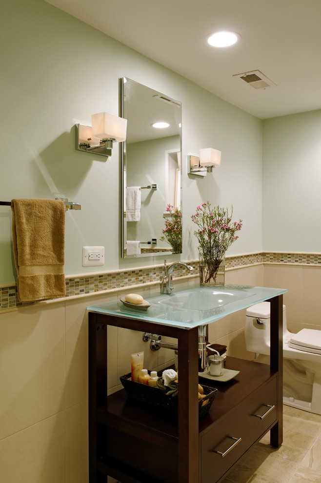 Photo of a medium sized classic shower room bathroom in DC Metro with beige tiles, solid surface worktops, an alcove shower, a one-piece toilet, green walls, recessed-panel cabinets, a freestanding bath, an integrated sink, beige floors, ceramic flooring, an open shower, brown cabinets and ceramic tiles.