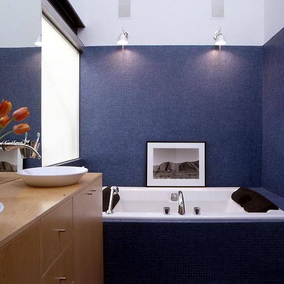 Contemporary bathroom in San Francisco with a vessel sink, freestanding cabinets, medium wood cabinets, wooden worktops, a built-in bath, blue tiles and mosaic tiles.