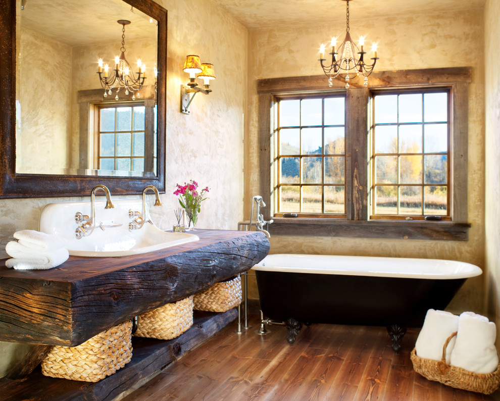 Mid-sized mountain style medium tone wood floor bathroom photo in Denver with an integrated sink, open cabinets, wood countertops and beige walls
