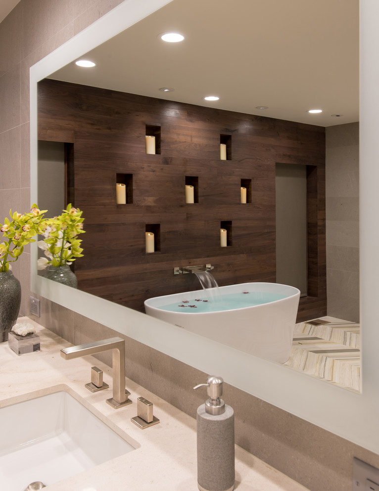Design ideas for an expansive contemporary ensuite bathroom in Dallas with flat-panel cabinets, light wood cabinets, a freestanding bath, a corner shower, a wall mounted toilet, grey tiles, porcelain tiles, grey walls, marble flooring, a submerged sink, quartz worktops, white floors and a hinged door.