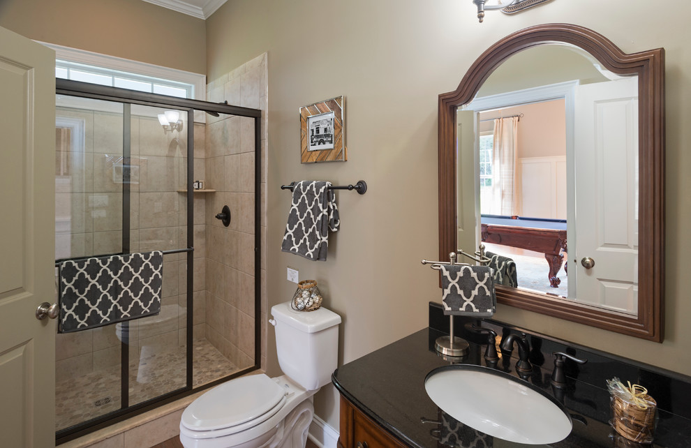 Example of a mid-sized classic 3/4 beige tile and pebble tile ceramic tile bathroom design in Richmond with a drop-in sink, furniture-like cabinets, medium tone wood cabinets, granite countertops, a one-piece toilet and beige walls