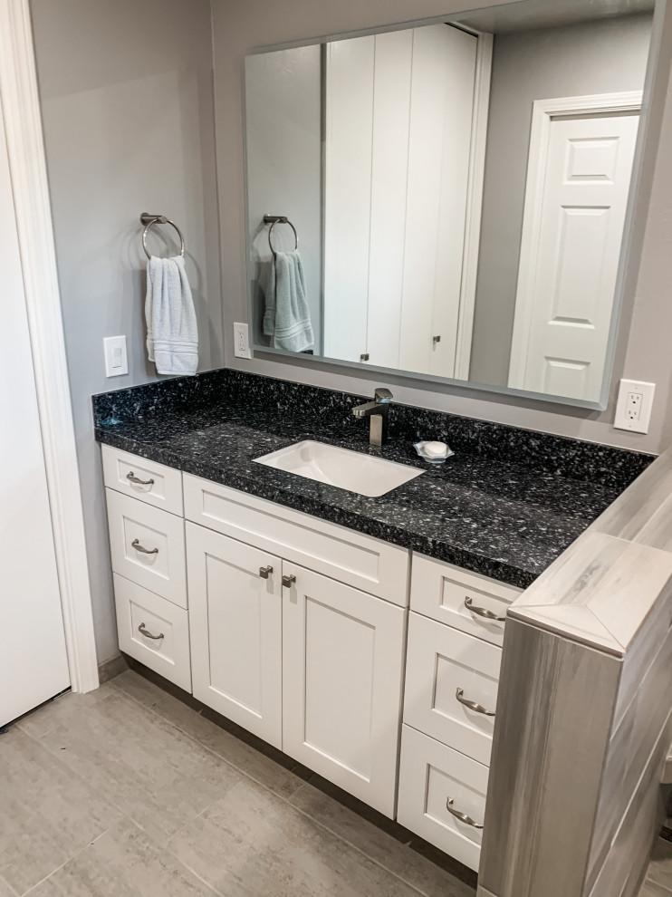 Example of a small trendy master gray tile and porcelain tile porcelain tile, gray floor and single-sink bathroom design in San Francisco with shaker cabinets, white cabinets, a one-piece toilet, gray walls, an undermount sink, quartz countertops, blue countertops and a built-in vanity