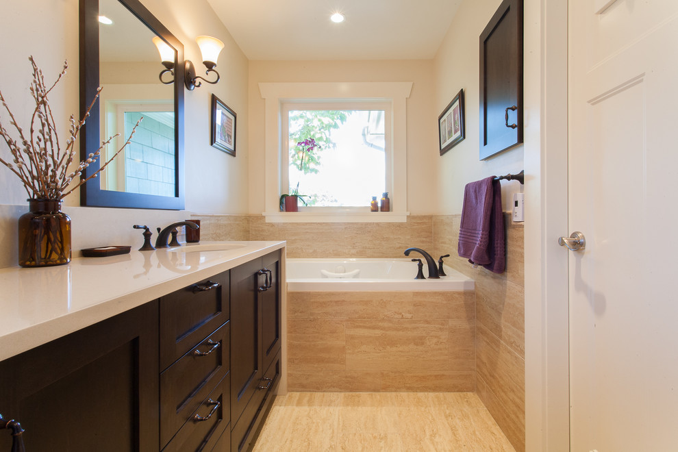 Example of a classic alcove bathtub design in Vancouver with recessed-panel cabinets and dark wood cabinets