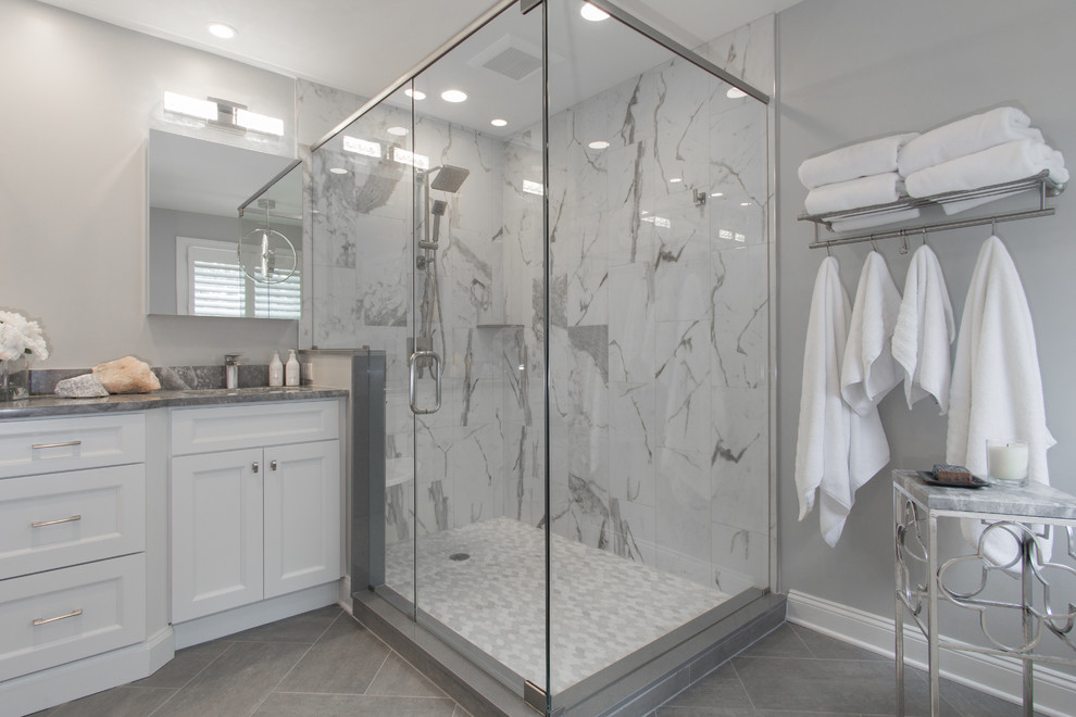 Bathroom - mid-sized contemporary master white tile and porcelain tile porcelain tile and gray floor bathroom idea in Philadelphia with shaker cabinets, white cabinets, a two-piece toilet, gray walls, an undermount sink, granite countertops, a hinged shower door and gray countertops