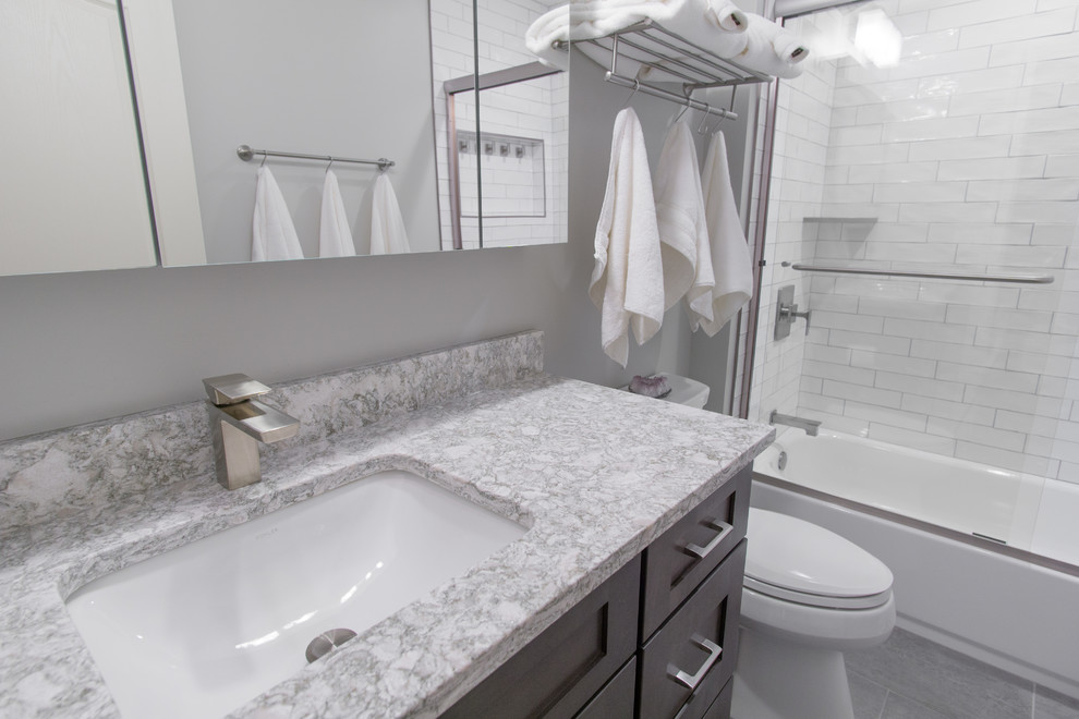 Inspiration for a medium sized contemporary shower room bathroom in Philadelphia with shaker cabinets, white cabinets, a freestanding bath, a walk-in shower, a two-piece toilet, white tiles, porcelain tiles, grey walls, porcelain flooring, a submerged sink, engineered stone worktops, grey floors, a sliding door and grey worktops.