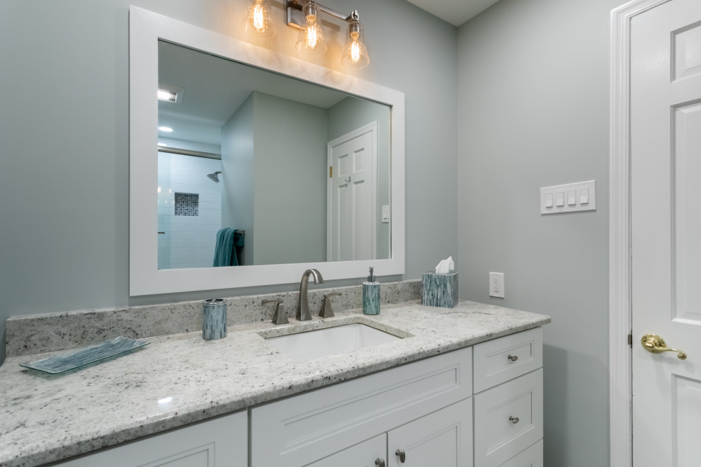 Small transitional master gray tile and ceramic tile vinyl floor and gray floor alcove bathtub photo in Philadelphia with shaker cabinets, white cabinets, a two-piece toilet, gray walls, an undermount sink, granite countertops and multicolored countertops