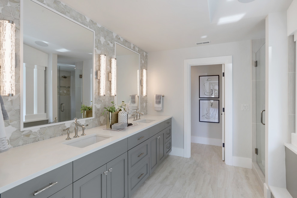 Design ideas for a medium sized contemporary ensuite bathroom in Seattle with recessed-panel cabinets, grey cabinets, a submerged bath, grey walls, porcelain flooring, a submerged sink, quartz worktops, white floors and white worktops.
