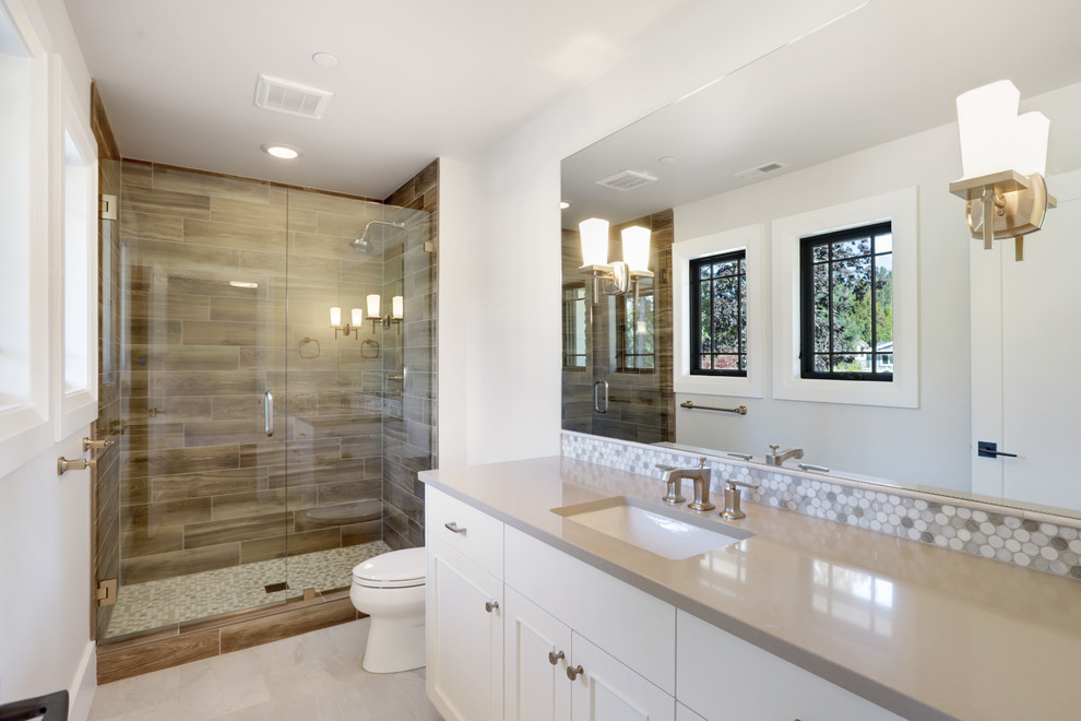 Large contemporary shower room bathroom in Seattle with recessed-panel cabinets, white cabinets, an alcove shower, brown tiles, porcelain tiles, grey walls, a submerged sink, beige floors, a hinged door and grey worktops.