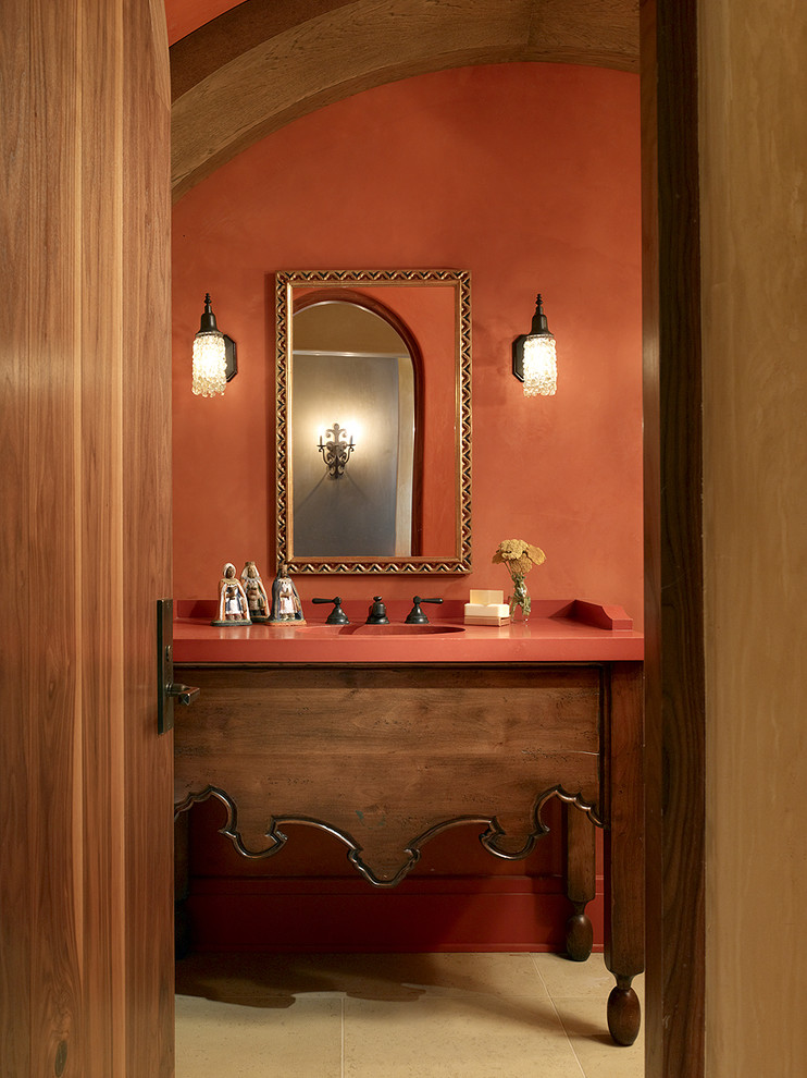 Inspiration for a mediterranean beige tile bathroom remodel in San Francisco with furniture-like cabinets, medium tone wood cabinets and orange walls