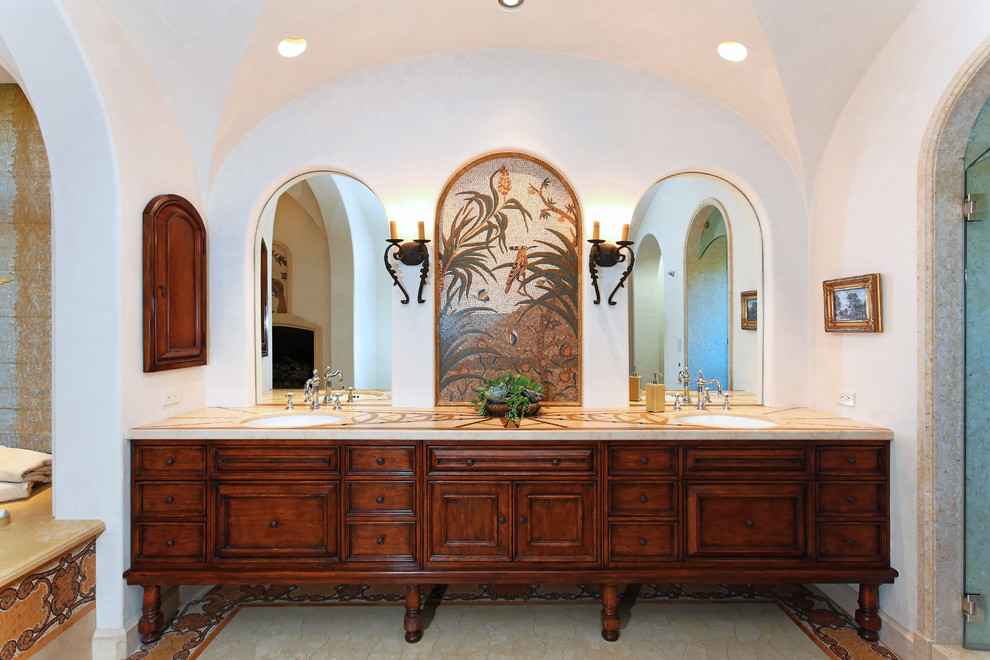 This is an example of a mediterranean bathroom in Other with dark wood cabinets and recessed-panel cabinets.