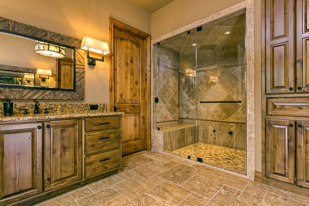 Photo of a large mediterranean ensuite bathroom in Austin with raised-panel cabinets, white cabinets, an alcove bath, a built-in shower, multi-coloured tiles, mosaic tiles, beige walls, porcelain flooring, a submerged sink and granite worktops.