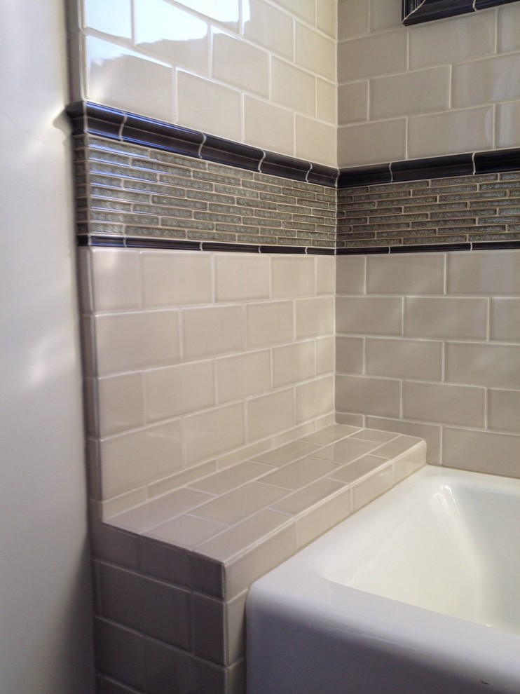 Photo of a medium sized traditional shower room bathroom in San Luis Obispo with open cabinets, dark wood cabinets, an alcove bath, a shower/bath combination, beige tiles, metro tiles, beige walls, ceramic flooring, an integrated sink, solid surface worktops, beige floors and a sliding door.