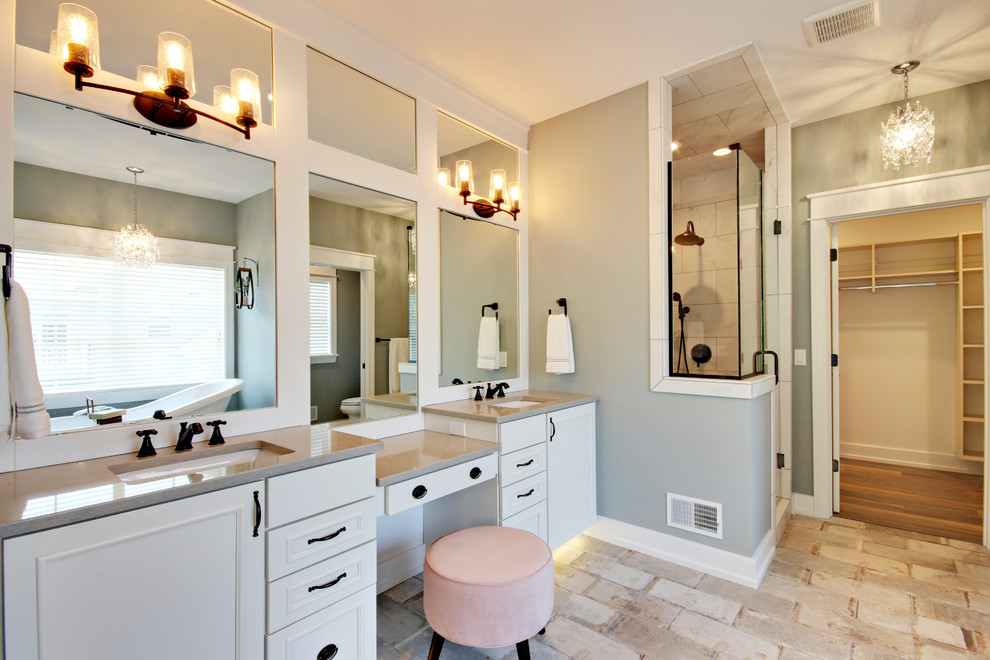 Classic bathroom in Grand Rapids with recessed-panel cabinets, white cabinets, a corner shower, grey walls, a submerged sink, beige floors, a hinged door and beige worktops.
