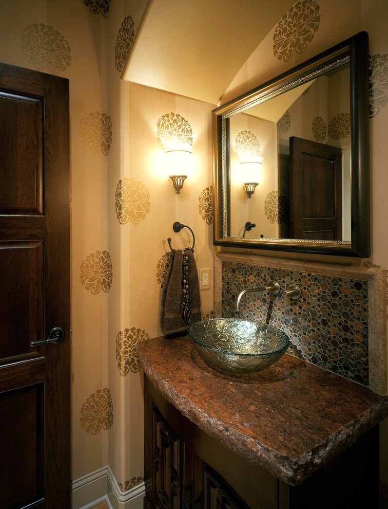 Mediterranean bathroom in Omaha with a vessel sink and feature lighting.