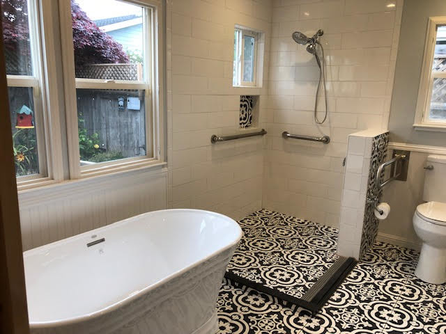 Photo of a medium sized mediterranean ensuite bathroom in San Francisco with a freestanding bath, a corner shower, a two-piece toilet, white tiles, ceramic tiles, grey walls, ceramic flooring, multi-coloured floors and an open shower.